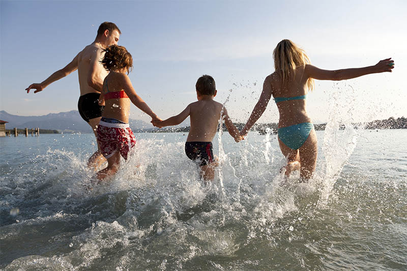 Familei mit zwei Kindern läuft ins Wasser